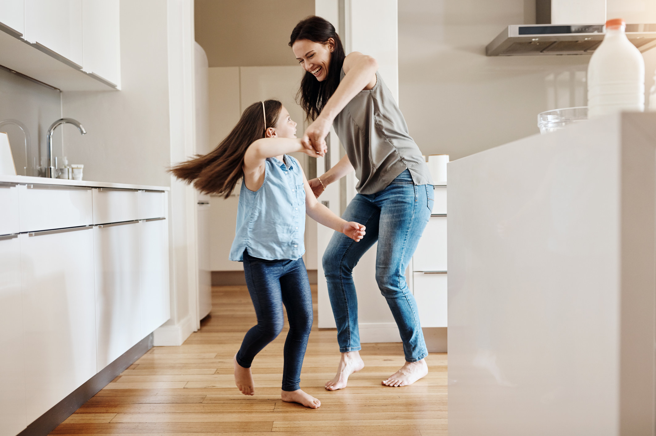 A mom dances with her daughter