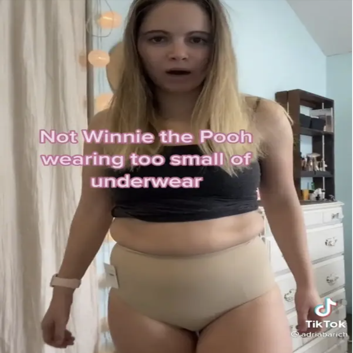 a girl trying on Skims calling herself Winnie the Pooh in too-small underwear
