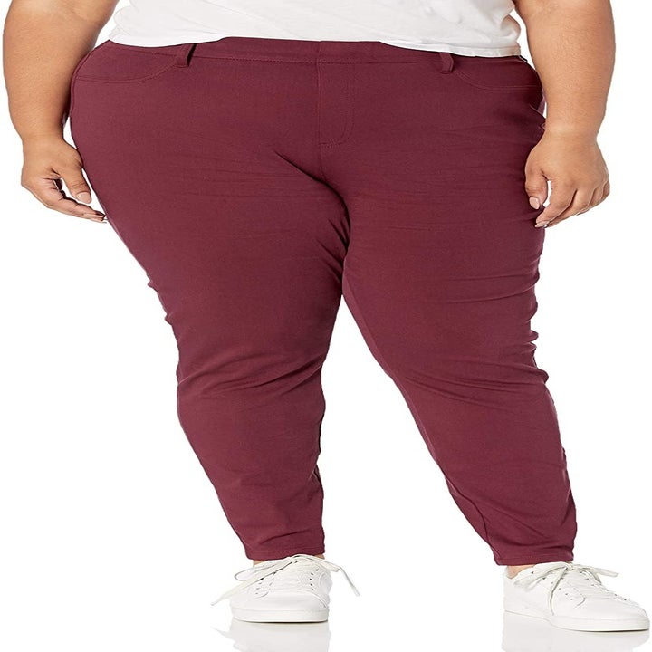 Model wearing the jeggings in burgundy 