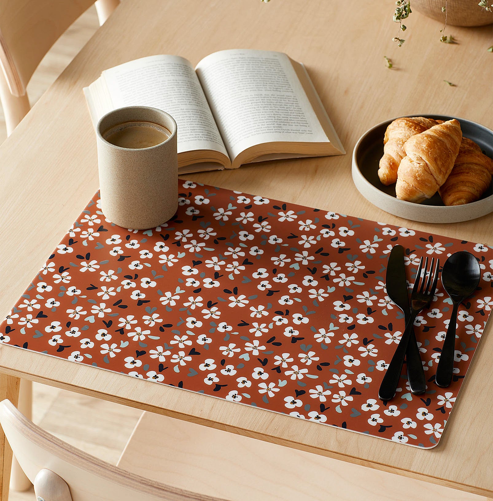 The floral placemat on a wooden table 