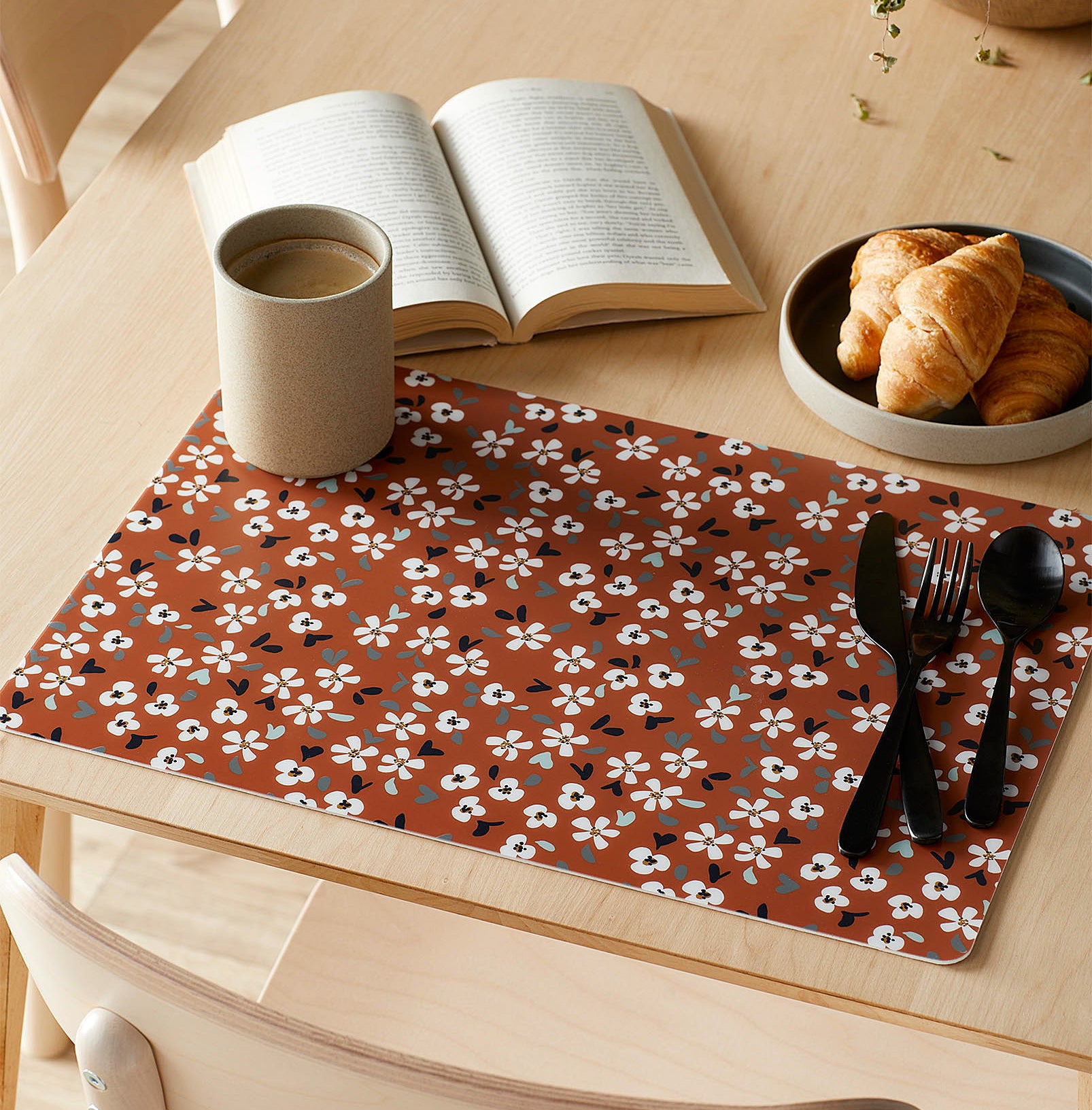 The floral placemat on a wooden table