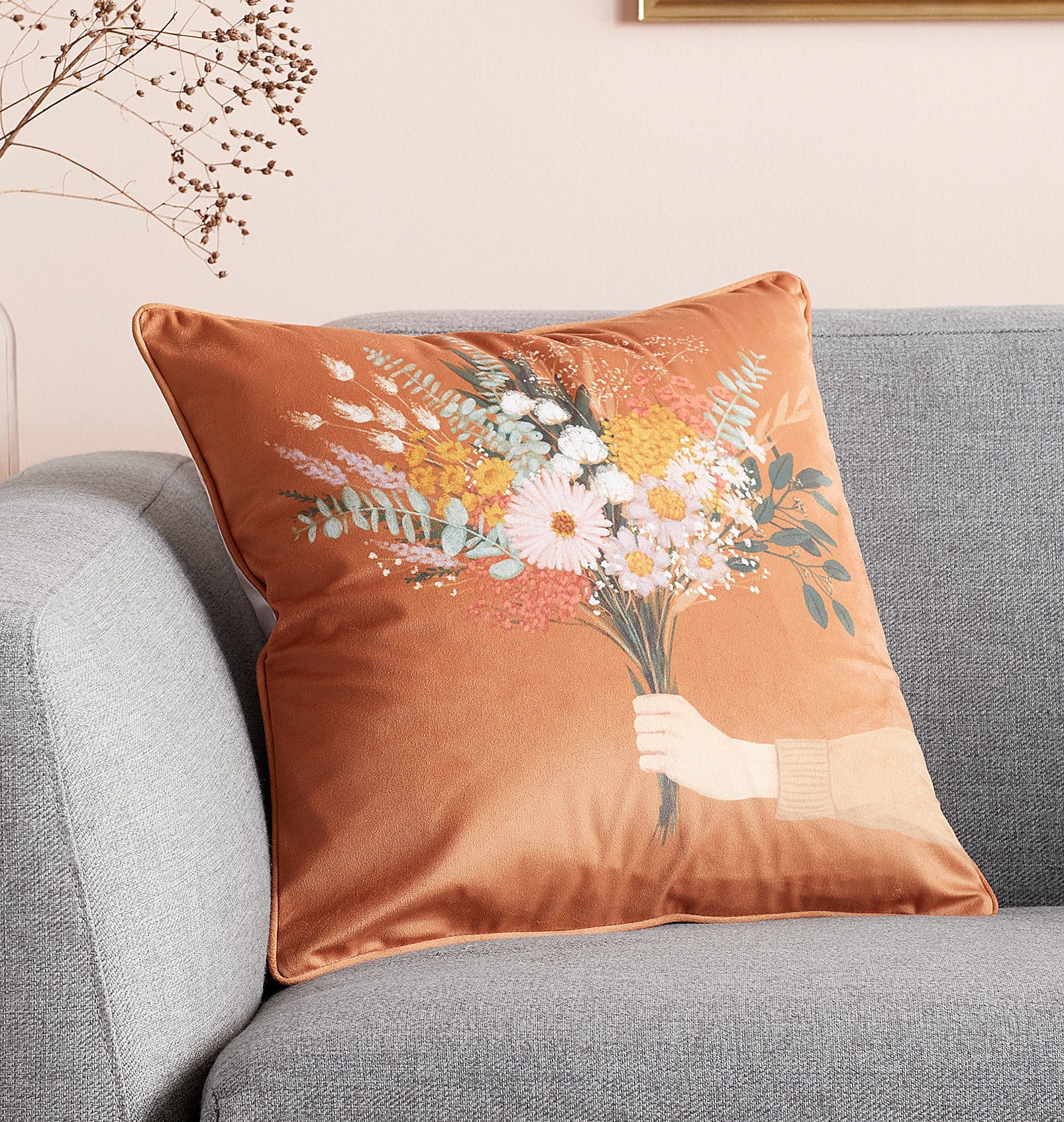 A floral throw pillow on a couch