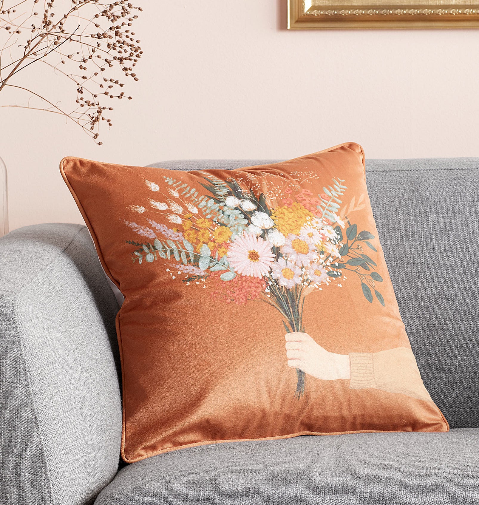 A floral throw pillow on a couch