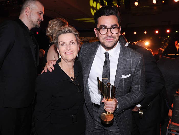 Dan and his mom while holding an award