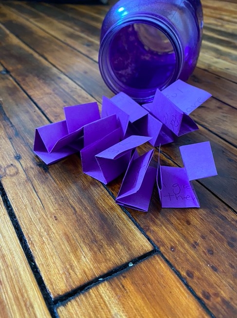 Pieces are poured out of a mason jar on hardwood floors. 