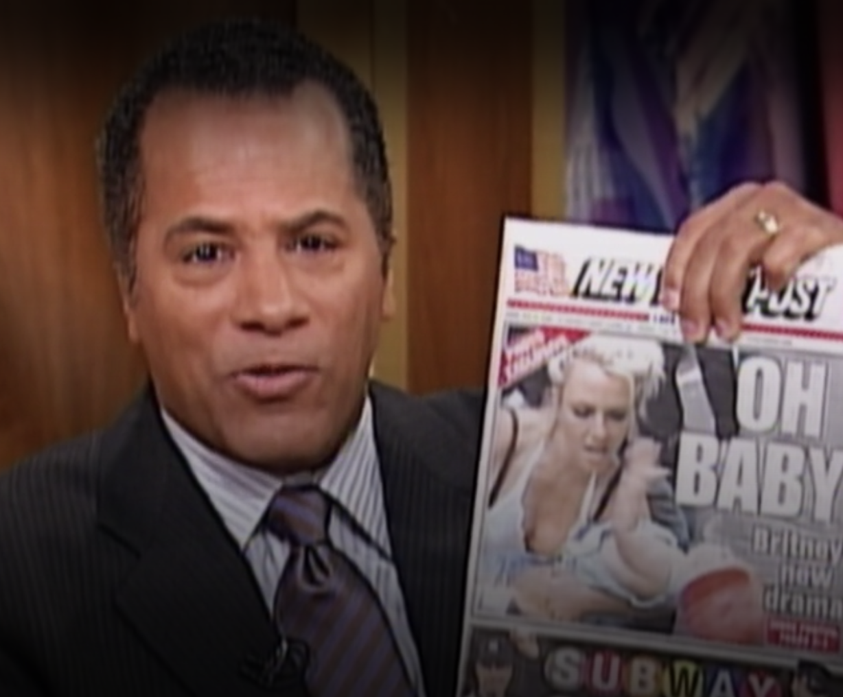 Lester Holt holding a picture of a New York Post cover with Britney holding her baby