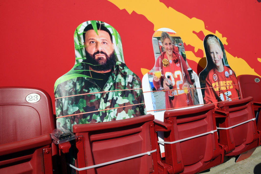 A cutout of DJ Khaled next to cutouts of a woman and a child