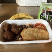 A box with a couple of falafel and a hash brown, paired with a juice box