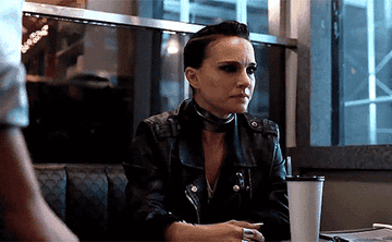 Natalie bangs her hand on the table in Vox Lux