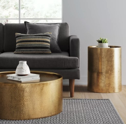 The gold drum style accent table in a living room