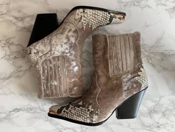 The mixed media boots with taupe-colored velvet and snakeskin accents and achromatic heel