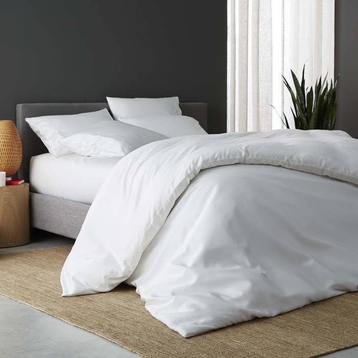 white duvet cover, sheets, and pillowcases on a bed