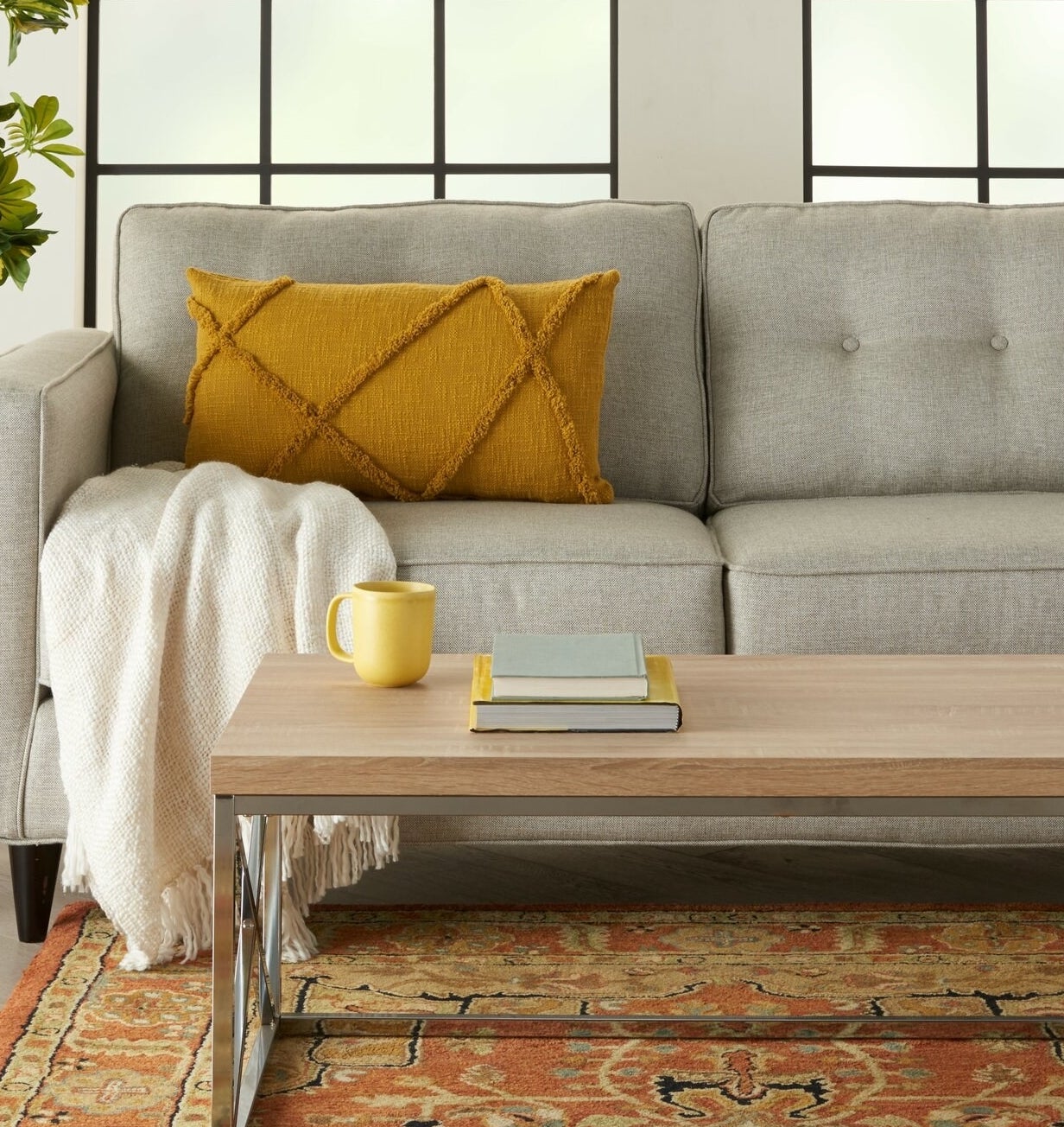 mustard yellow pillow on a gray couch