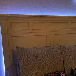 The light strips installed out of sight behind a headboard so only the glow is visible