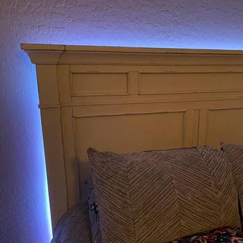 The light strips installed out of sight behind a headboard so only the glow is visible