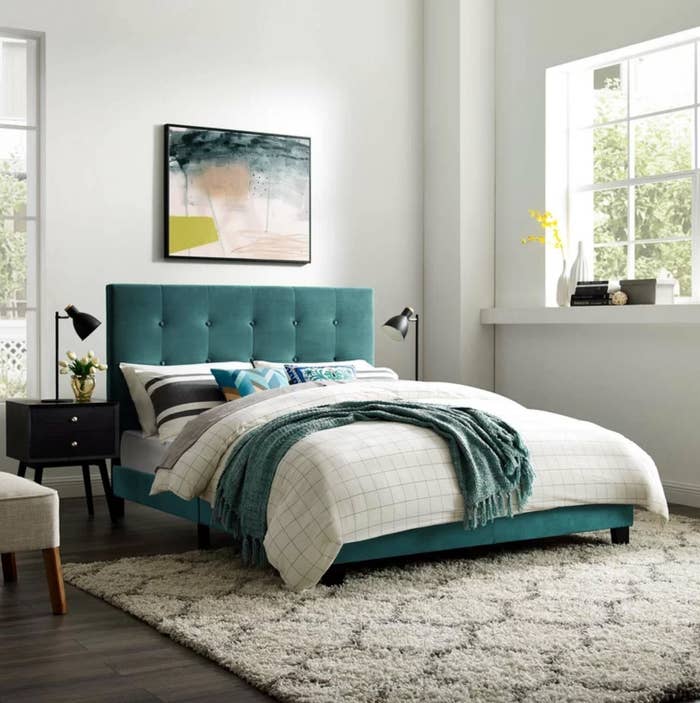 The upholstered platform bed frame in sea blue