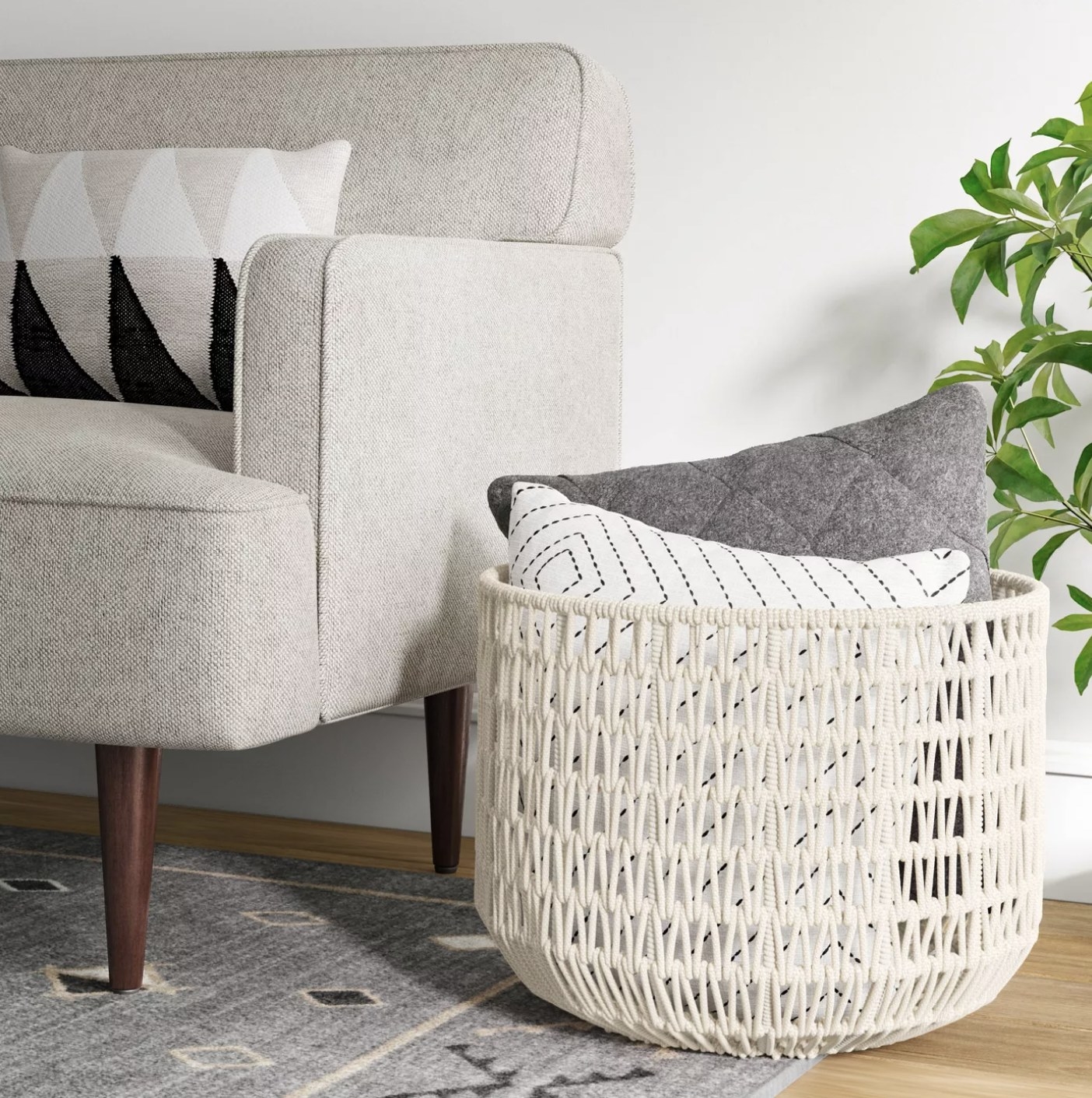 The cream rope basket with pillows inside of it