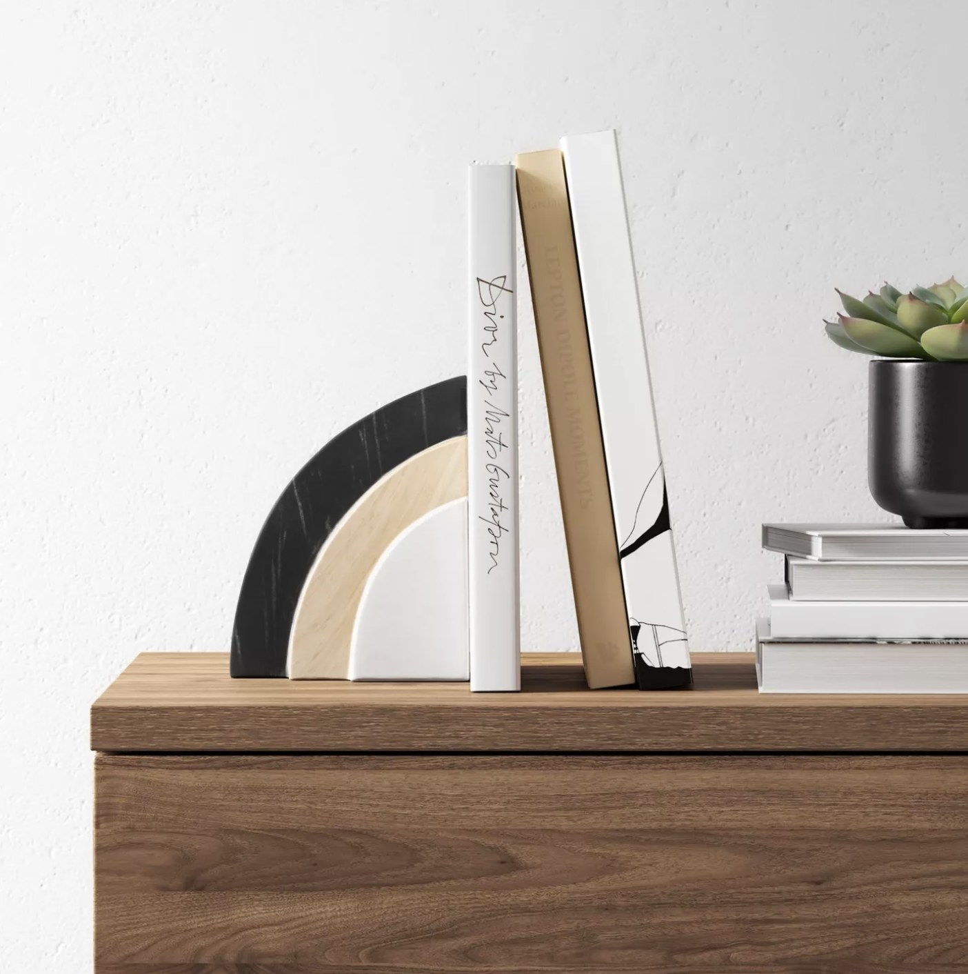 The marble bookend on a table holding up books