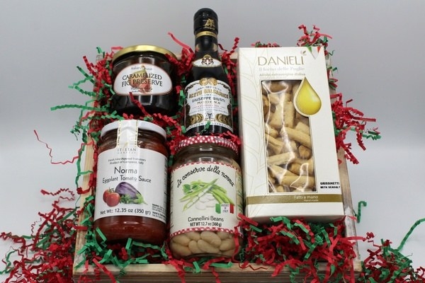 box filled with italian gourmet goods like eggplant tomato sauce, fig preserve, and cannellini beans