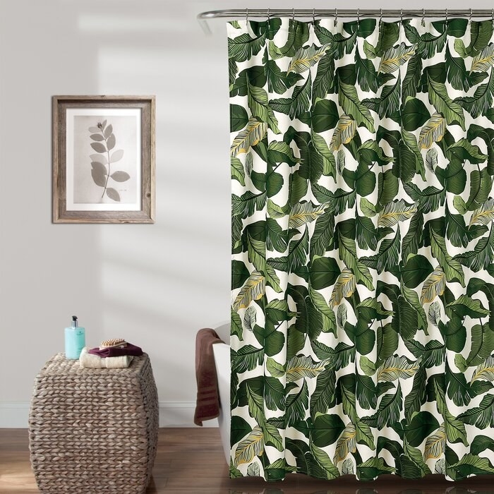 shower curtain with a leafy green pattern on it