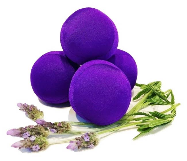 Four small round purple balls next to lavender 