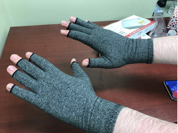 Reviewer with gray fingerless compression gloves on hands 
