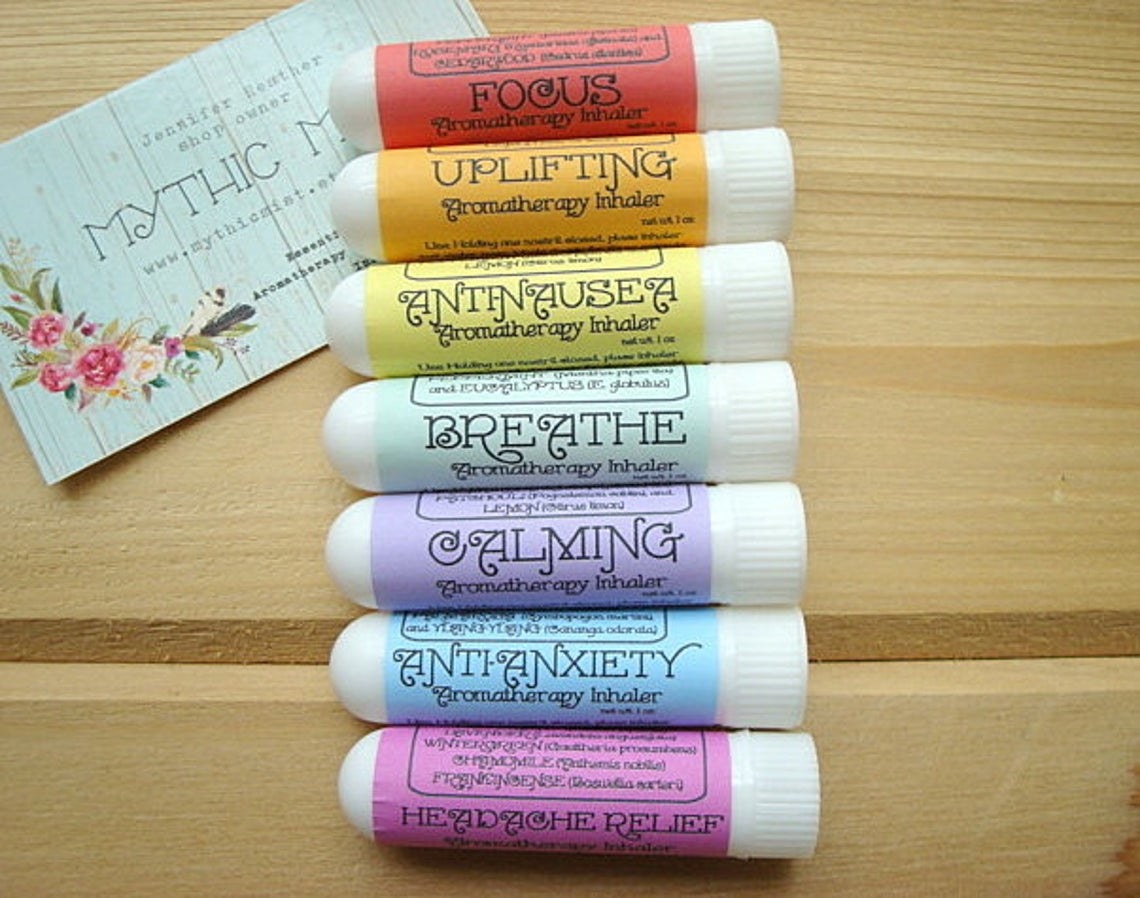 seven aromatherapy inhalers laid out in rainbow colors