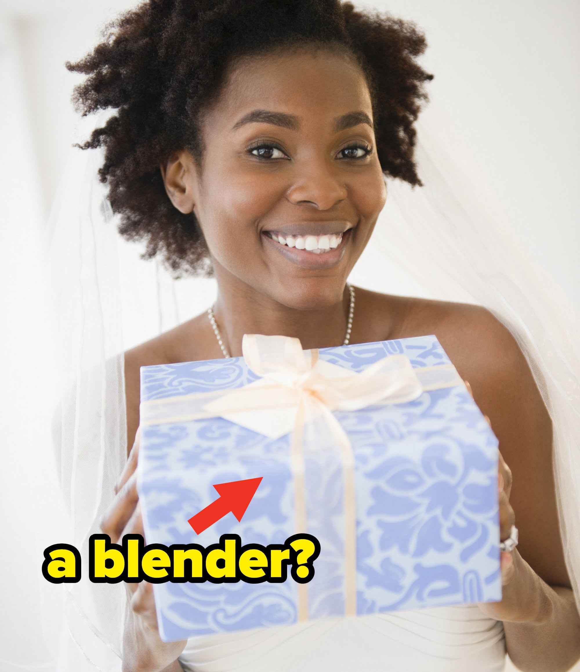 A bride holding a wrapped wedding gift with a question caption: "a blender?"