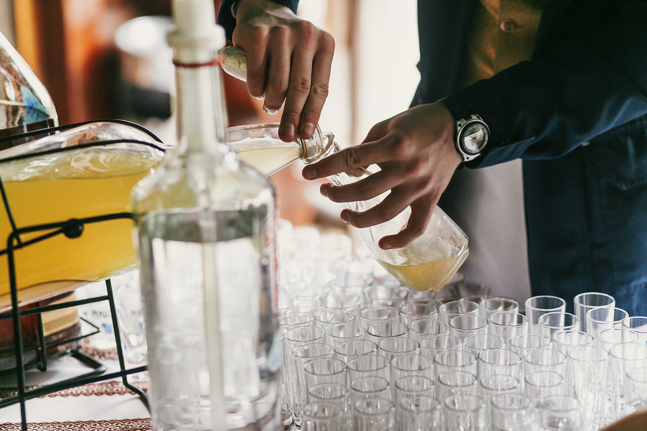 A waiter pouring a drink at a wedding party