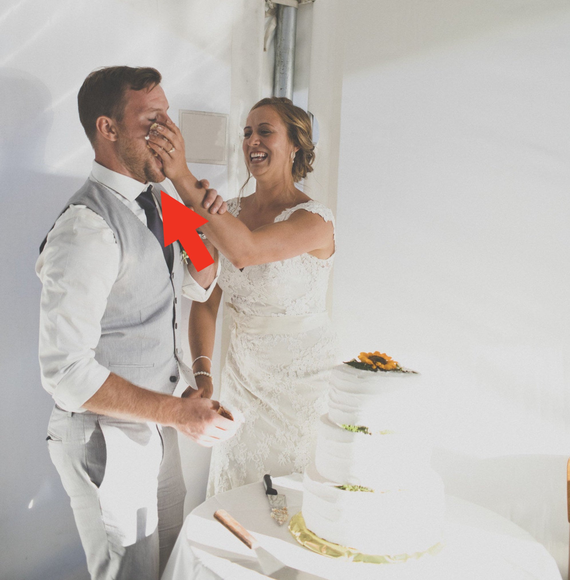 A bride shoves cake into the groom&#x27;s face