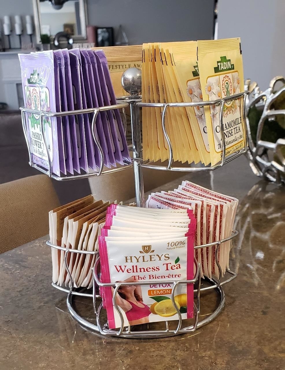 A reviewer&#x27;s photo of the silver carousel holding various tea packets