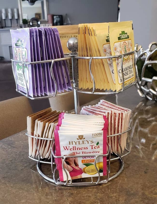 A reviewer's photo of the silver carousel holding various tea packets