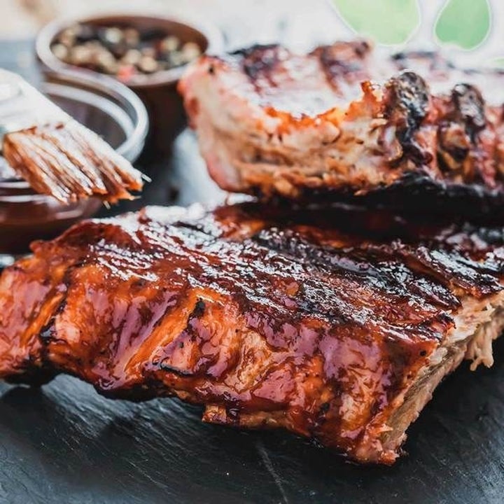 A close-up of barbecue ribs covered in sauce 