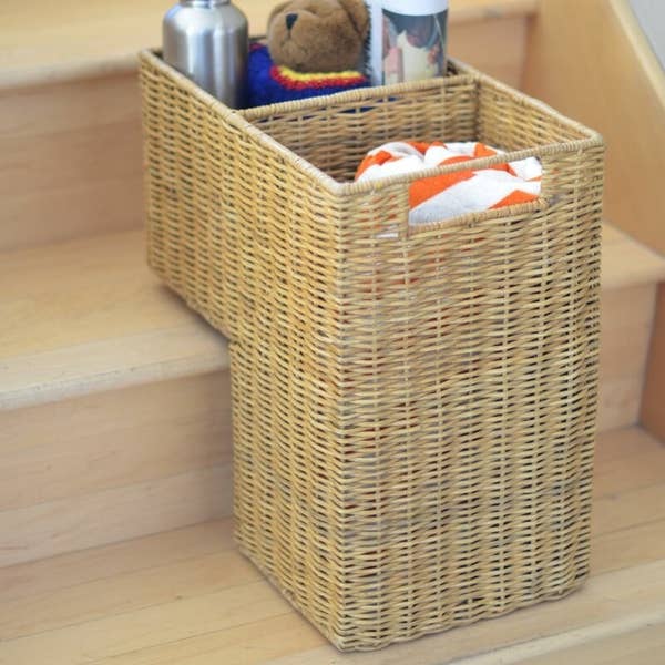 The wicker basket holding a towel, water bottle, and teddy bear
