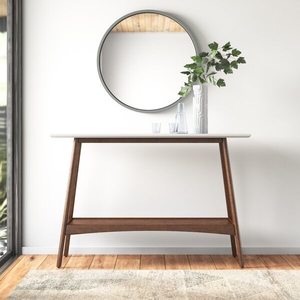 The console table with white top and wooden legs and base