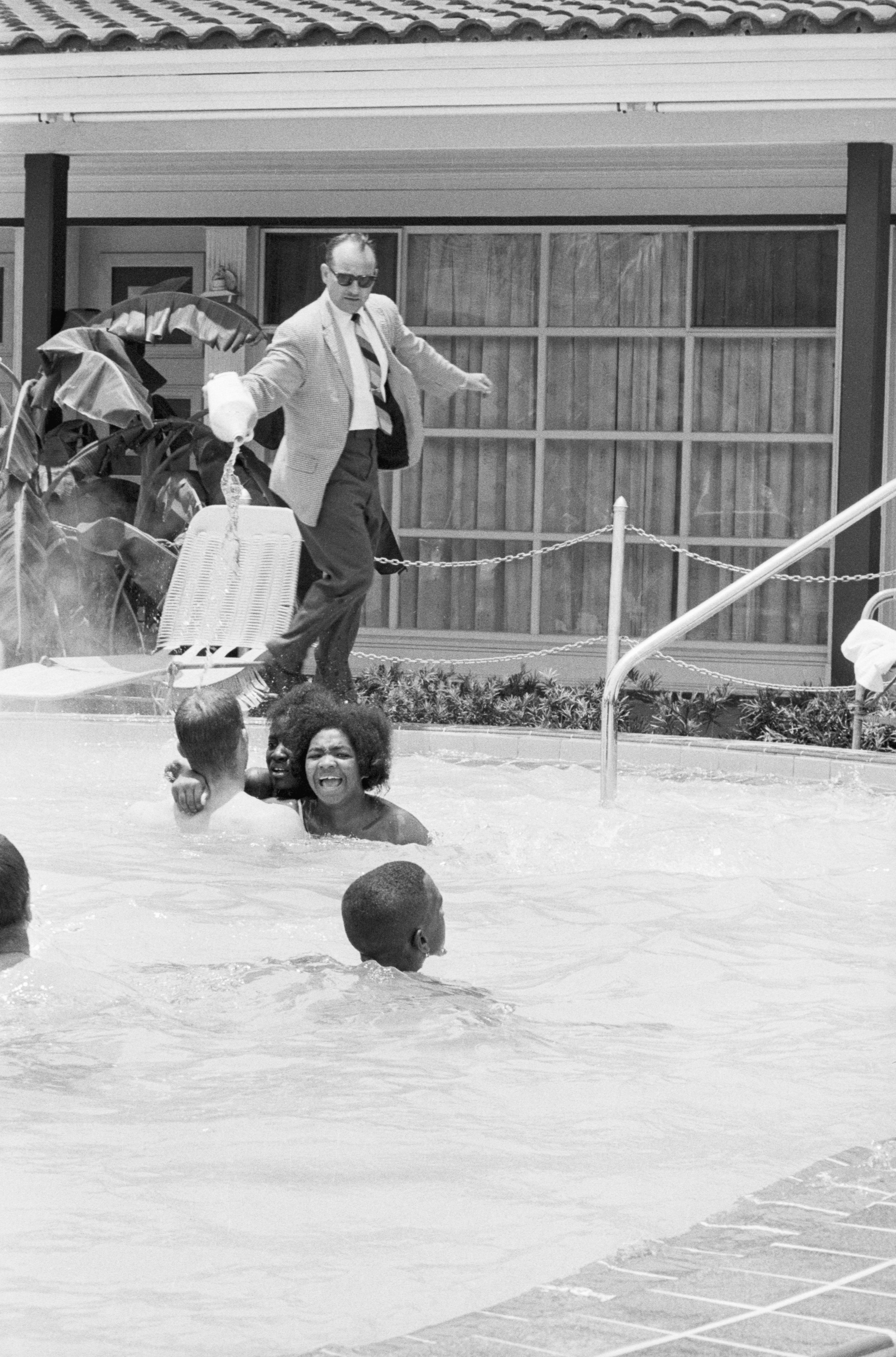 A clear image from the screenshotted video showing protesters demonstrating in the swimming pool of the Monson Motor Lodge in Saint Augustine, Florida scream as motel manager James Brock dumps &quot;muriatic acid&quot; into the water