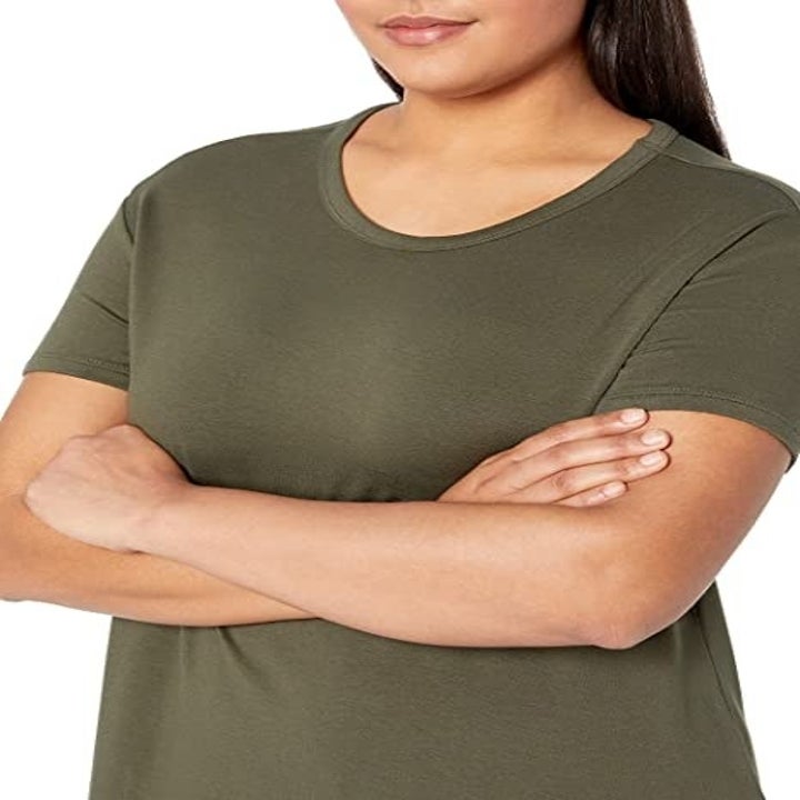 Closeup of model wearing the T-shirt dress in olive green
