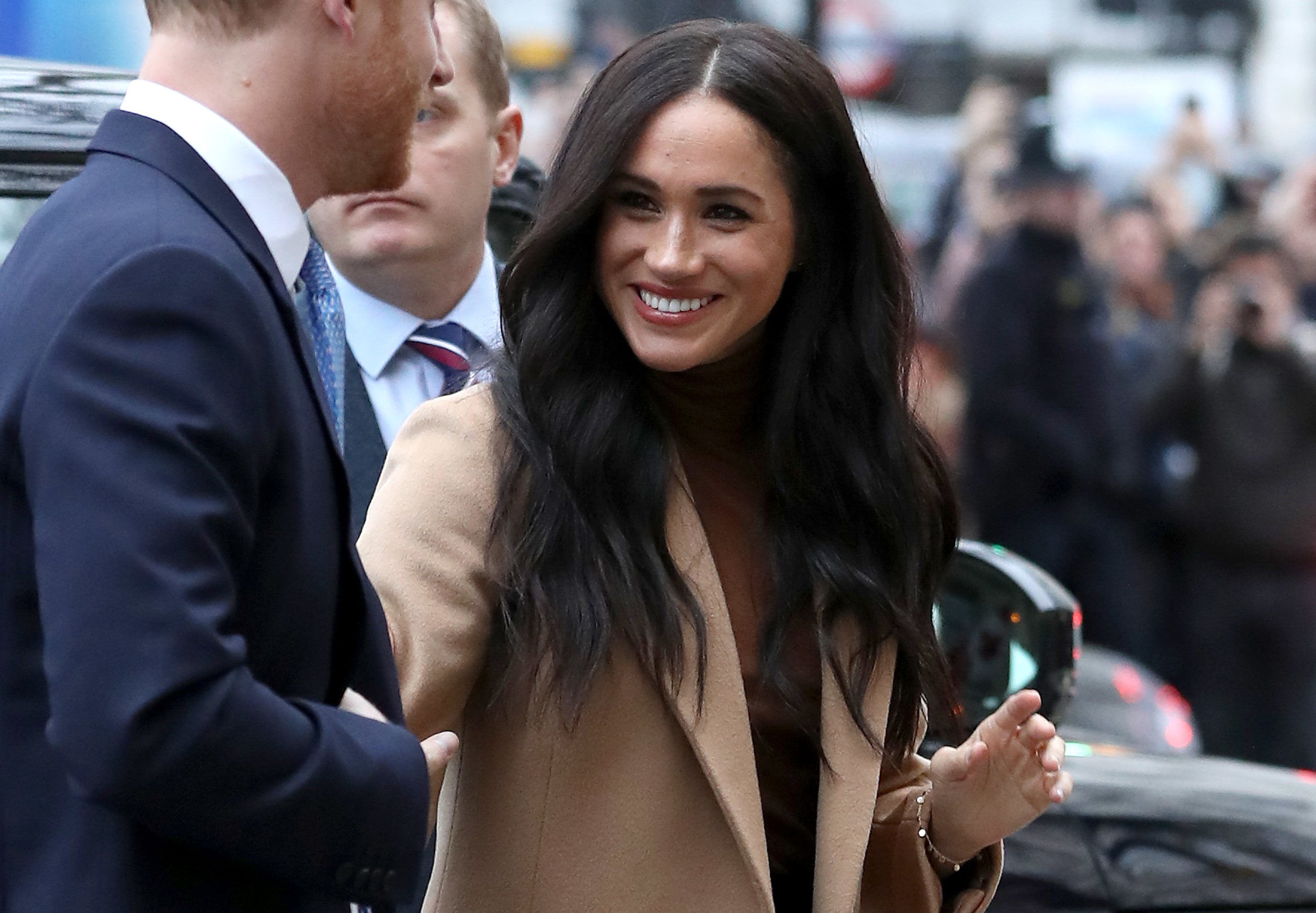 Meghan smiles on her way to an event