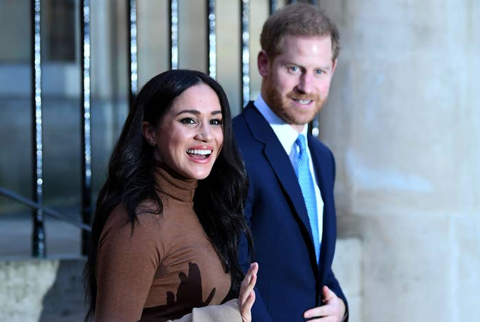 Meghan and Harry smile while on their way to an event