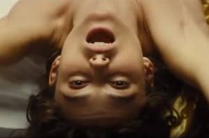 Anna lying upside down with her mouth open in Anna Karenina