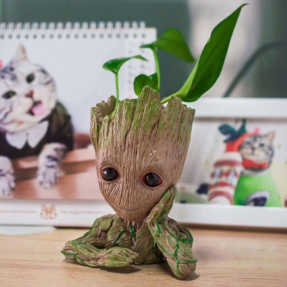 A Groot flower pot with a plant in it 