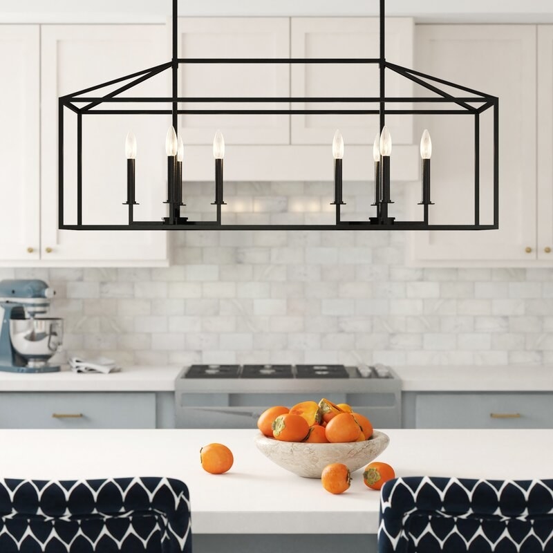 The black pendant light hung over a kitchen island
