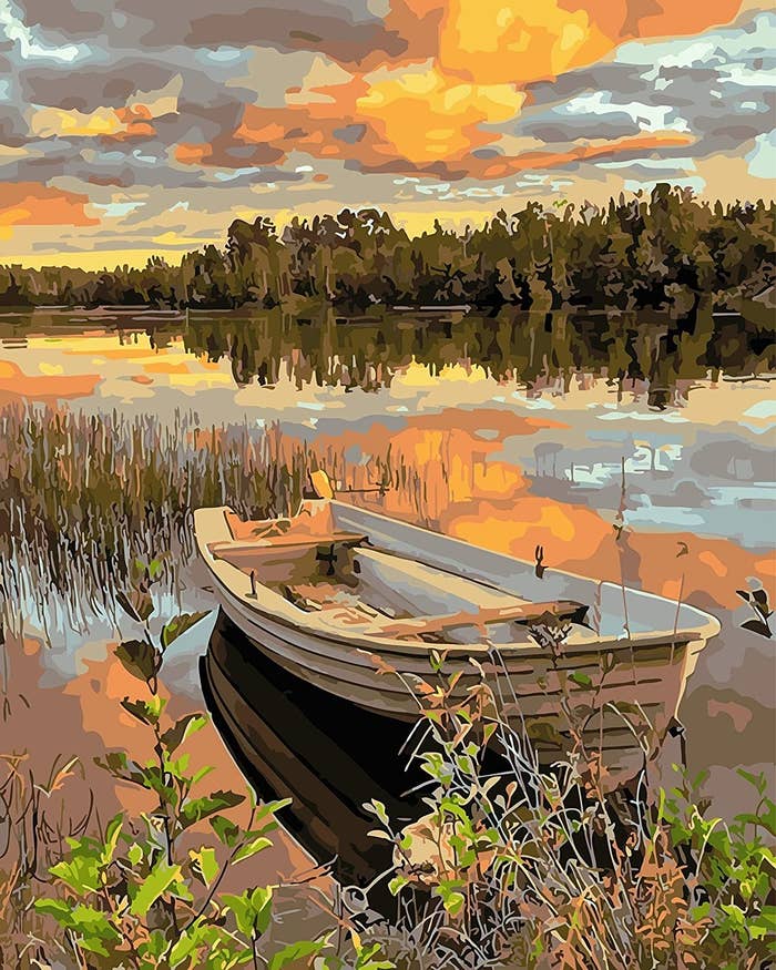 The paint by numbers finished product of a canoe sitting in a serene lake 