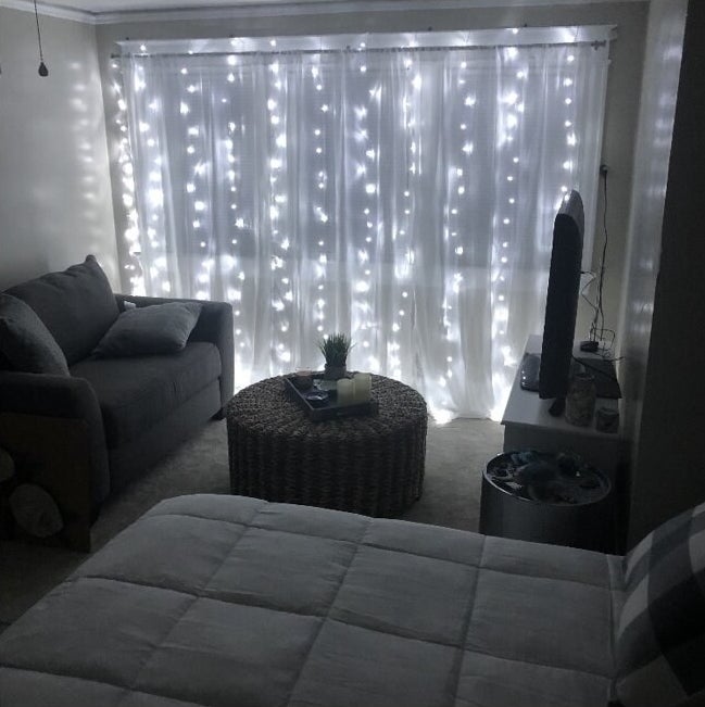 white string light curtain in a bedroom