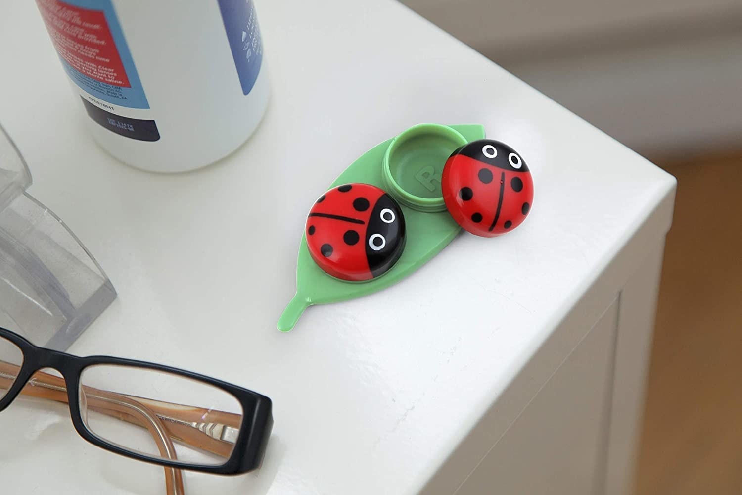 the lady bug contact case on a table