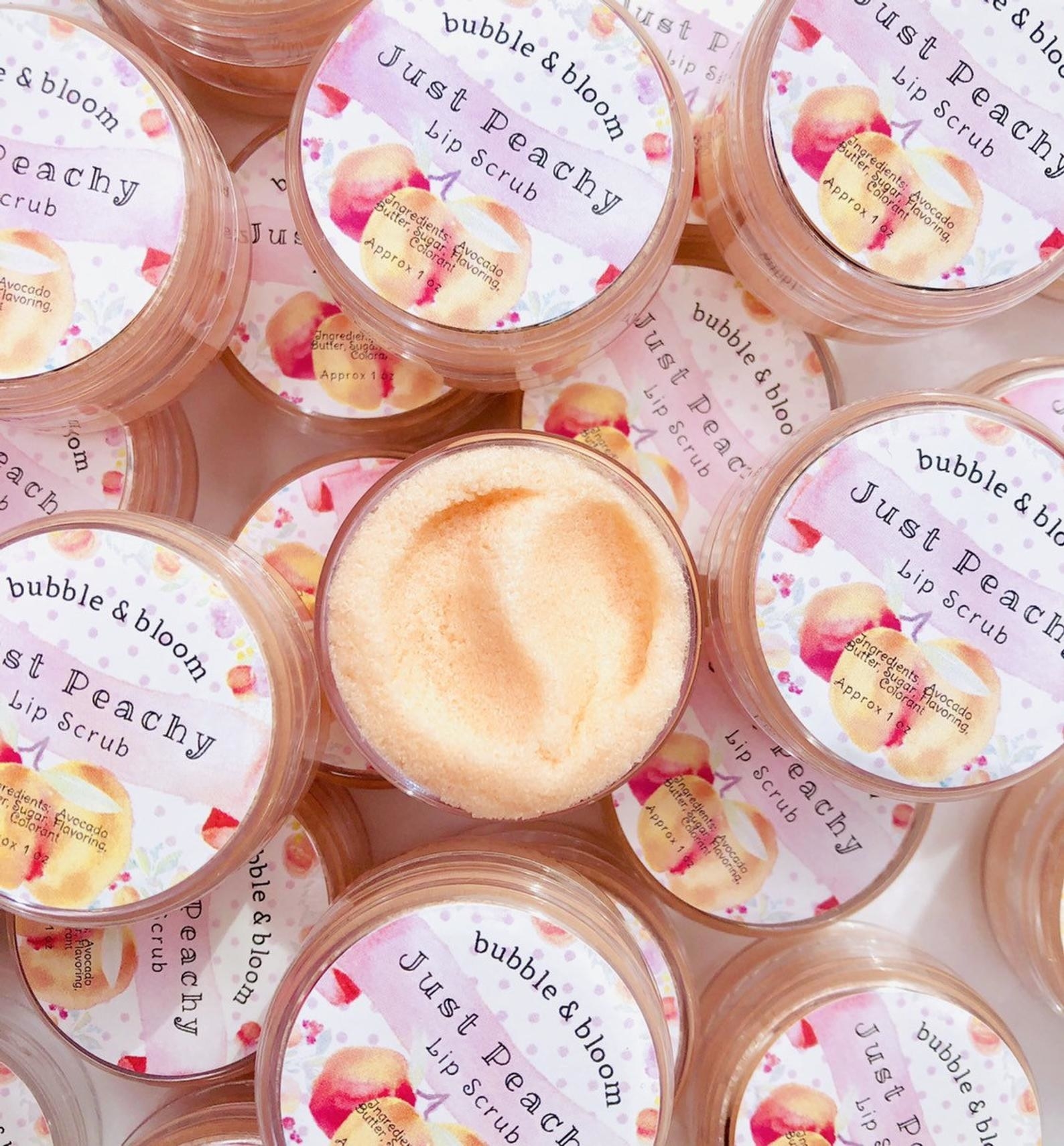A small container of peach-colored &quot;just peachy&quot; lip scrub 