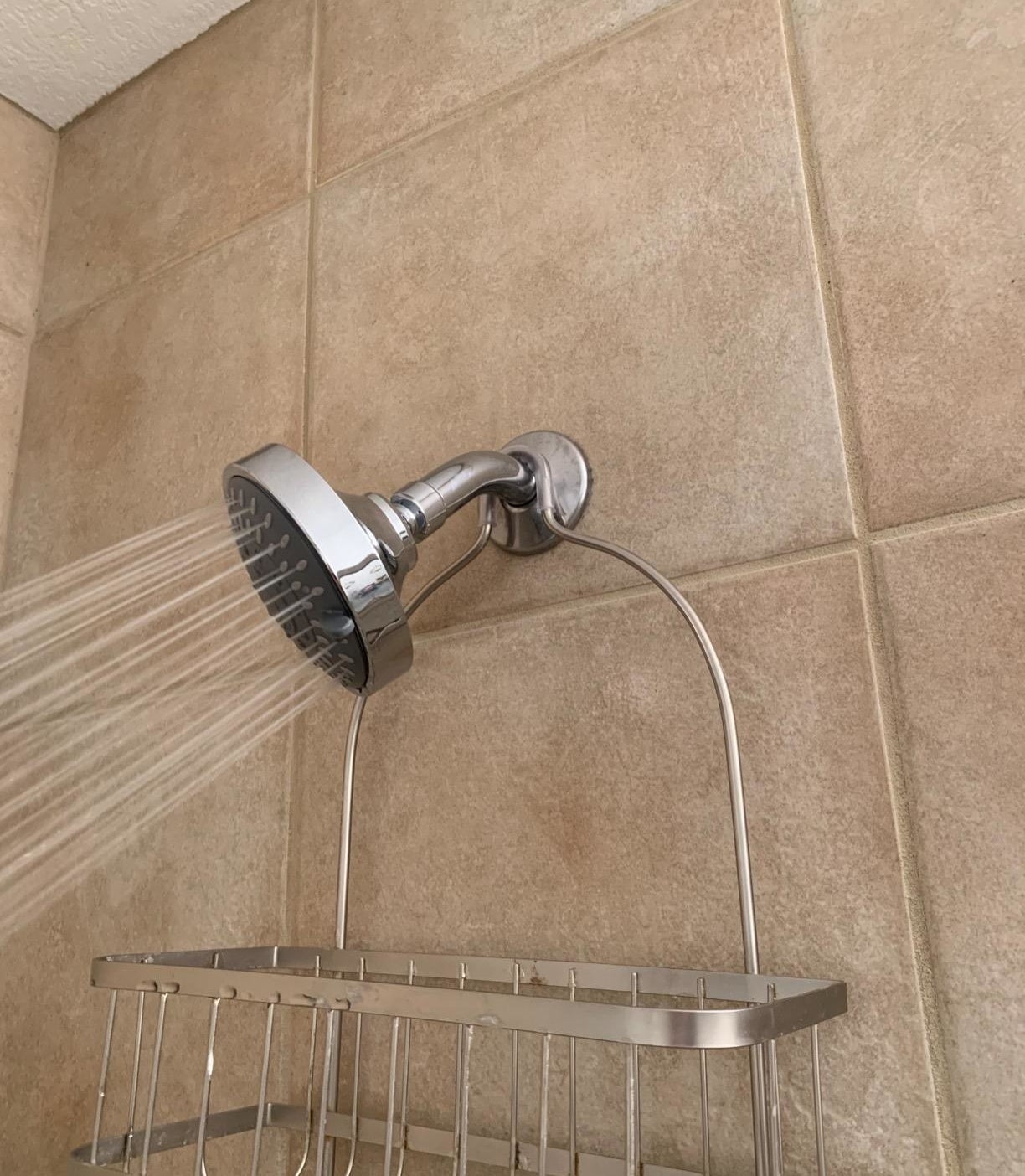 reviewer image of the warmspray shower head spraying high pressure water on the rain setting