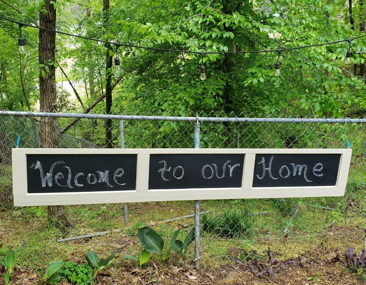 reviewer image of garage door panel with chalkboard paint and a message that reads "welcome to our home" in chalk
