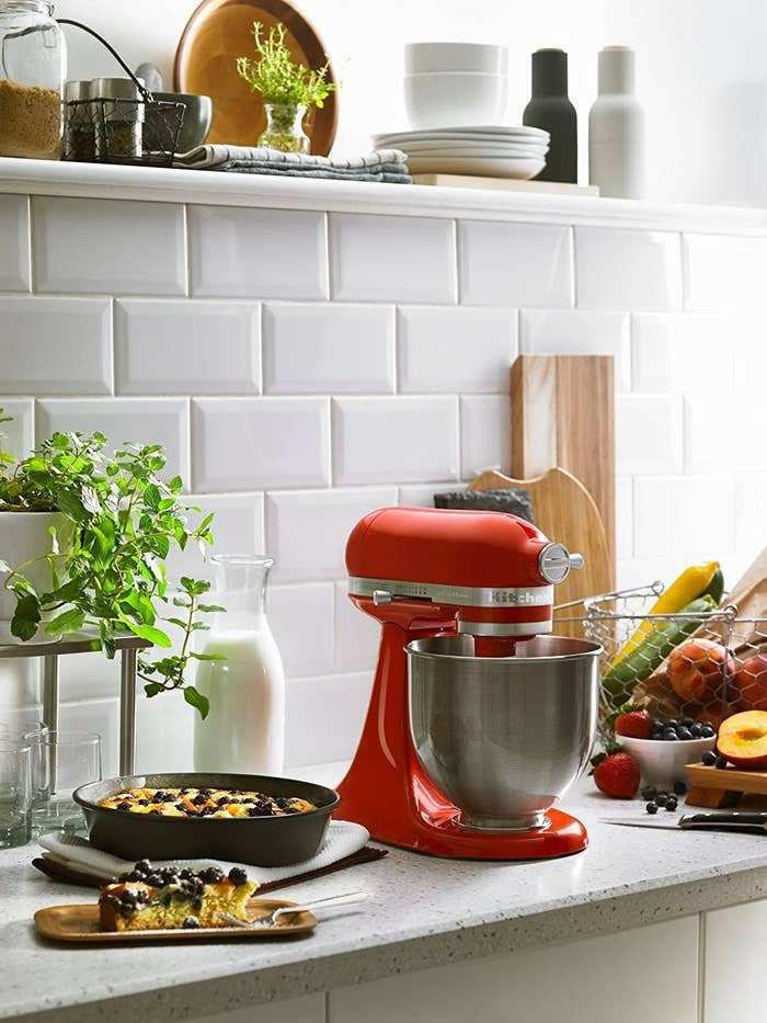 Small stand mixer around vegetables and baked goods 