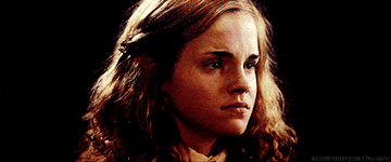 Hermione trying not to cry and shaking her head